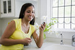 Photo: Hispanic woman listening to music on mp3 player Hispanic woman listening to music on mp3 player