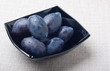 Black glass bowl with plums Black glass bowl with plums