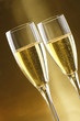 Glasses of champagne with gold background with walnuts, candels