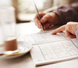 Woman trying to solve Sudoku Puzzle