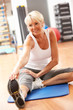 Photo: Senior Woman Doing Stretching Exercises In Gym Senior Woman Doing Stretching Exercises In Gym