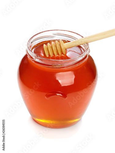 Photo: Wooden dipper with jar of honey. Wooden dipper with jar of honey.
