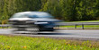 Photo: Fast moving modern car with led lights on highway Fast moving modern car with led lights on highway
