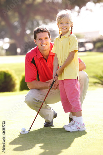 Photo: Father Teaching Daughter To Play Golf On Putting On Green Father Teaching Daughter To Play Golf On Putting On Green
