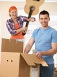 Woman pretending to attack man with guitar