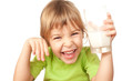 small girl in green blouse wriggles and drinks tasty fresh milk