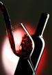 Pouring red vine into glass with bottle in the background. Pouring red vine into glass with bottle in the background.