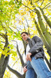 Young man standing in a forest in autumn