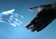 Human hand touch an atrifical glass hand Human hand touch an atrifical glass hand