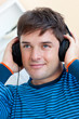 portrait of a handsome man listening music with earphones