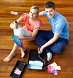 Young couple sitting on floor smiling