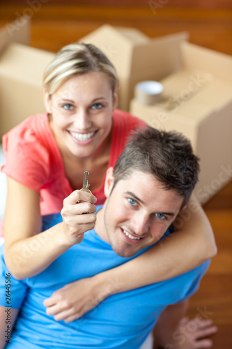 Photo: Young couple holding a key Young couple holding a key