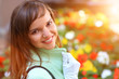 Beautiful young woman looking back on flowers background Beautiful young woman looking back on flowers background