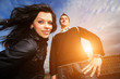 Photo: Happy cool young couple in city at sunset Happy cool young couple in city at sunset