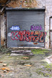 Images : Rolling door covered with graffiti in an abandoned warehouse