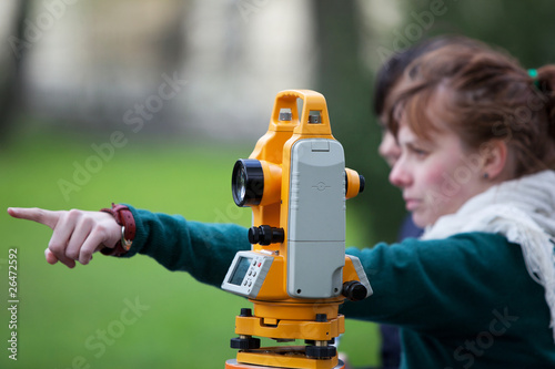 Photo: young land surveyor at work young land surveyor at work