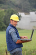 Engineer standing in front of dam under construction Engineer standing in front of dam under construction