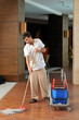 Young housekeeper mobbing the floor - a series of HOTEL images.