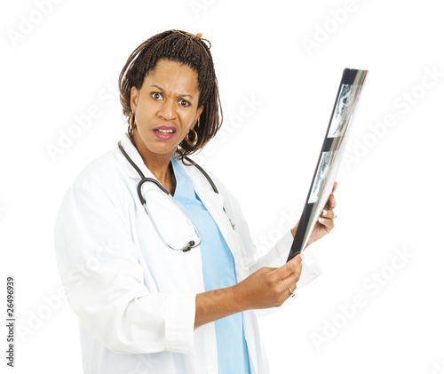 Photo: Confused Doctor With X-Ray Results Confused Doctor With X-Ray Results
