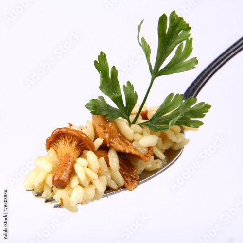 Photo: Risotto with mushrooms decorated with parsley on a fork Risotto with mushrooms decorated with parsley on a fork