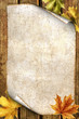 old paper with autumn leaves on wood