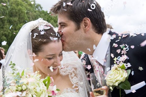 Photo: Bride and Groom in confetti shower Bride and Groom in confetti shower