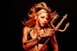 Photo: Beautiful devil with trident and Halloween accessories on black Beautiful devil with trident and Halloween accessories on black