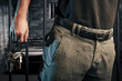 prison guard with keys walking outside dark prison cell