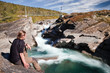 Wanderer am wilden Fluss in Lappland