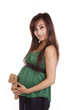 Pregnant woman in green with bear looking