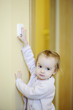 Adorable girl turning off the light-switch