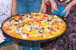 Valencian paella rice held by women