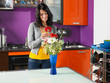 woman arranging flowers in pot