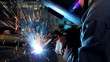 Welder at work in factory