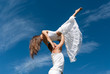 young couple dancing on sky background, freedom and relax symbol