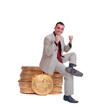 business man sitting on gold coins business man sitting on gold coins