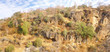 Sparse brush clings to barren rocky hillsides Rajasthan,