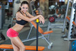 Girl with perfect body in fitness hall