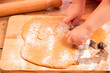 little girl with cutter make a gingerbread man cookie little girl with cutter make a gingerbread man cookie