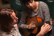 Young Musician Teaches Female Student To Play the Guitar Young Musician Teaches Female Student To Play the Guitar