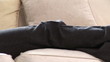 Assertive woman on the phone lying on the sofa at home