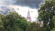 Video: Big Ben surrounded by trees with moving clouds on background Big Ben surrounded by trees with moving clouds on background