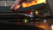 Close up of a dj scratching a disc on his mixer during a party