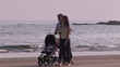 Serene scene of a young family on the beach at sunset