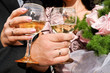 two hands holding glasses of champagne