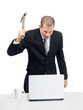 Furious businessman destroying his laptop with a hammer Furious businessman destroying his laptop with a hammer