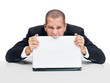 Frustrated young businessman biting his laptop