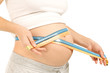 Measuring tape around protuberant abdomen