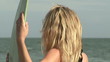 Female surfer feeling the wind on the beach
