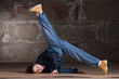 Hip hop dancer in modern style over brick wall